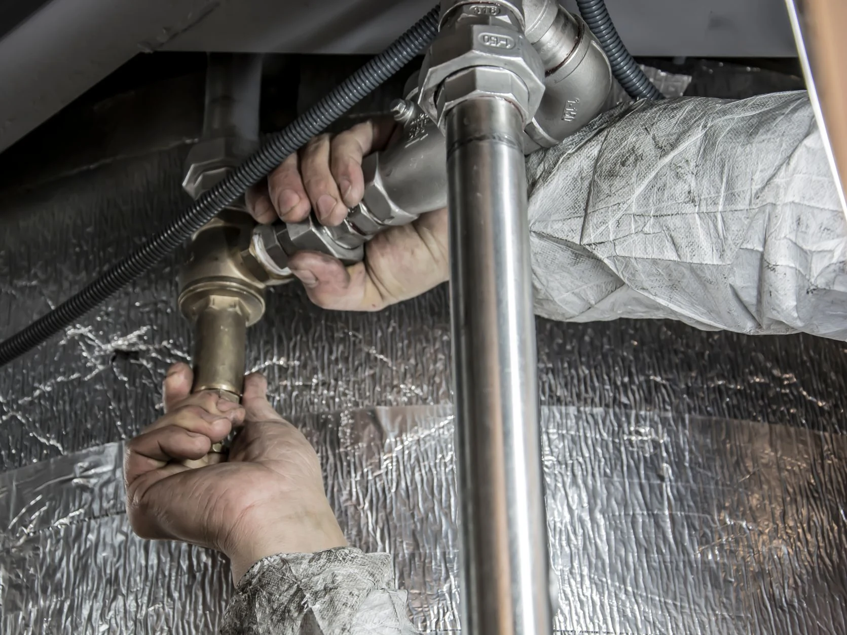 plumber working at Oakley Plumbing And Heating Solutions
